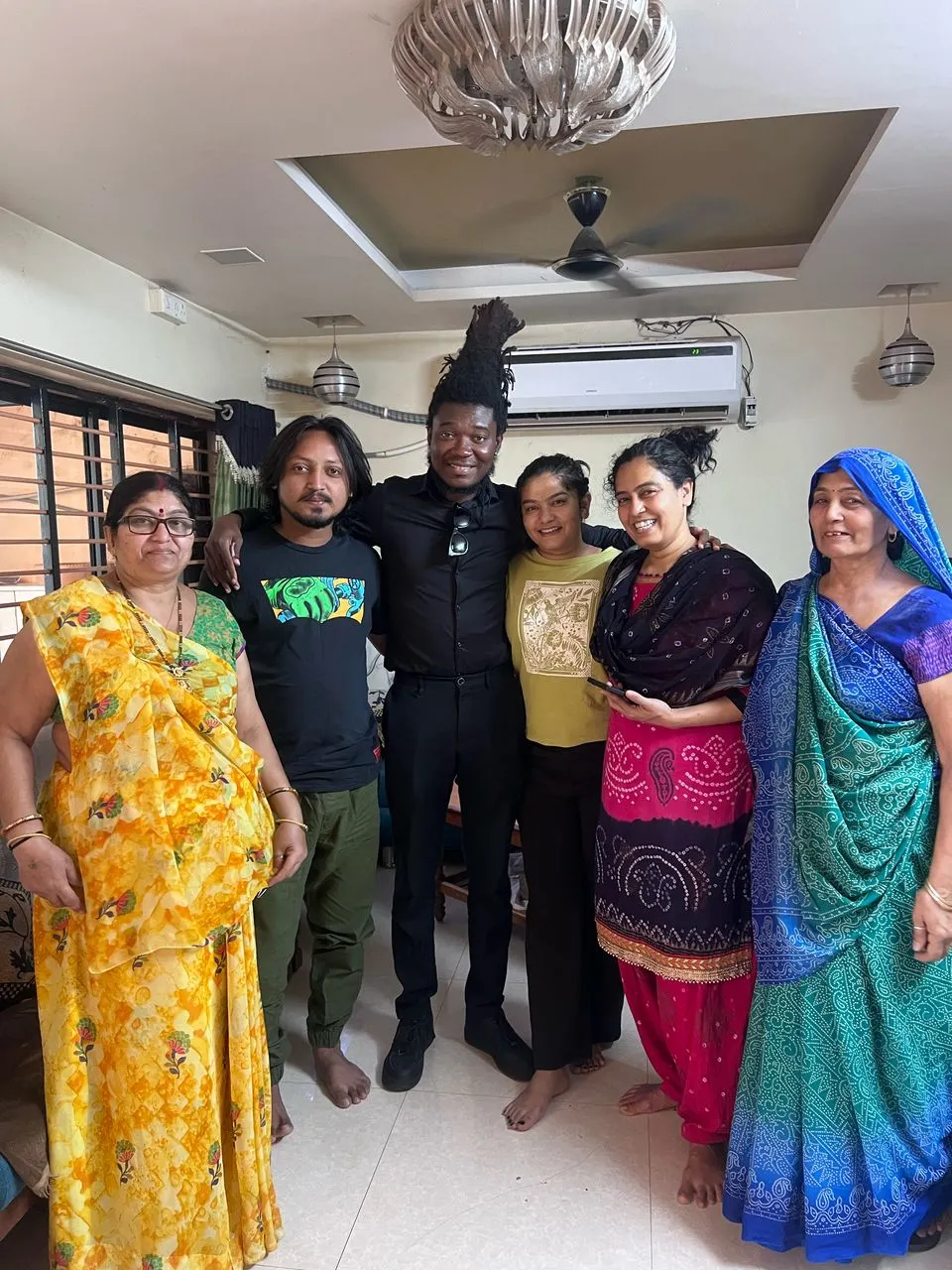 Joseph and a group posing together indoors during his visit to India.